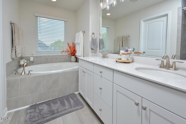 490 Mallard Loop Dr, Clayton, NC 27527 - bathroom featuring visible vents, double vanity, a garden tub, and a sink
