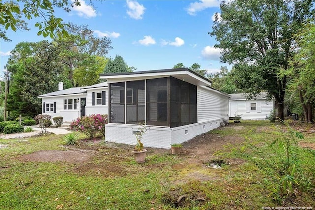 413 Lincoln Mckay Dr, Lillington, NC 27546 - rear view of property with a chimney, a sunroom, and a yard
