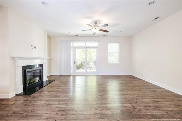 234 Hugh Shelton Loop, Fayetteville, NC 28301 - unfurnished living room with a ceiling fan, wood finished floors, a glass covered fireplace, baseboards, and recessed lighting