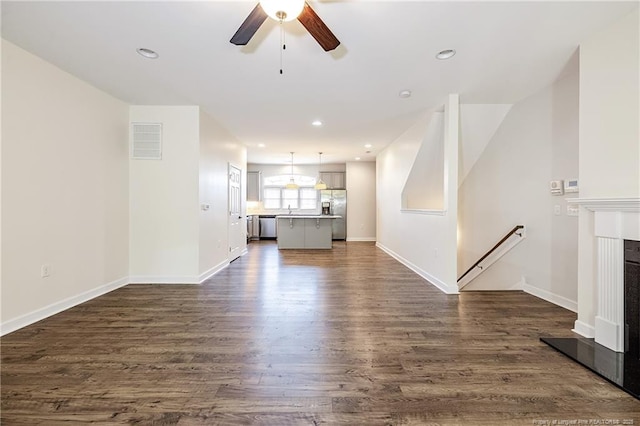 234 Hugh Shelton Loop, Fayetteville, NC 28301 - unfurnished living room with a ceiling fan, dark wood finished floors, baseboards, recessed lighting, and a sink