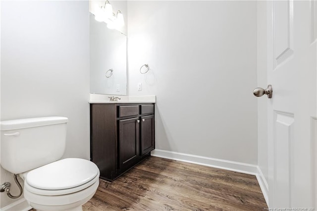 234 Hugh Shelton Loop, Fayetteville, NC 28301 - bathroom featuring wood finished floors, vanity, toilet, and baseboards