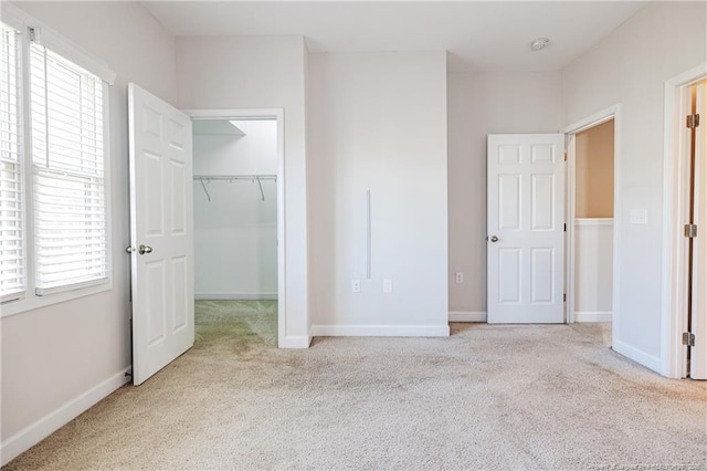 234 Hugh Shelton Loop, Fayetteville, NC 28301 - unfurnished bedroom featuring carpet floors, a walk in closet, a closet, and baseboards