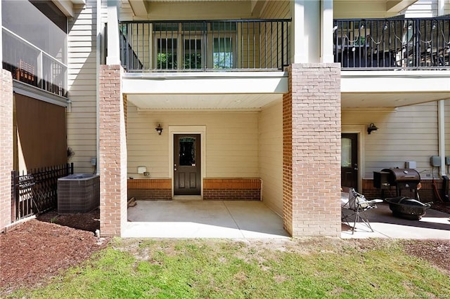 234 Hugh Shelton Loop, Fayetteville, NC 28301 - rear view of property featuring cooling unit, a patio area, brick siding, and a balcony