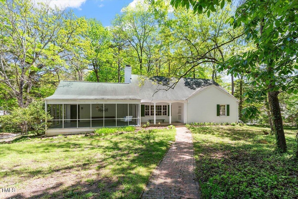 803 Old Mill Rd, Chapel Hill, NC 27514 - back of house featuring a yard, a sunroom, a chimney, and roof with shingles