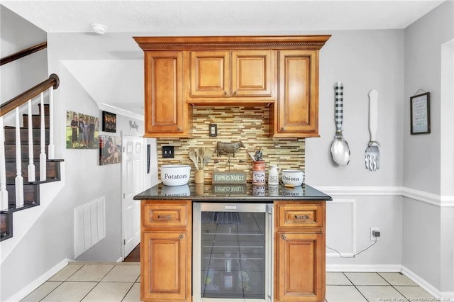 bar featuring stairway, tasteful backsplash, light tile patterned flooring, wine cooler, and visible vents