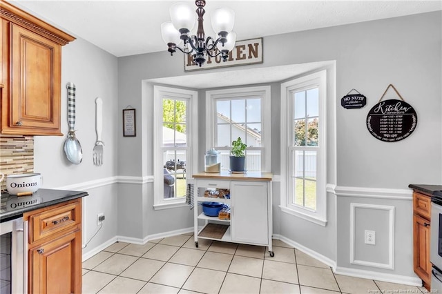 doorway with baseboards, a chandelier, wine cooler, and light tile patterned floors