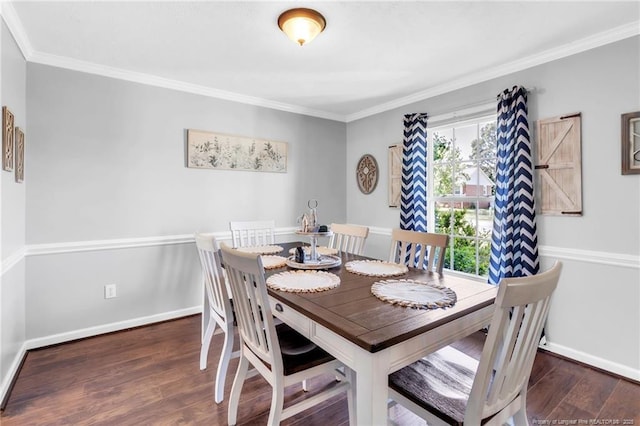 dining room featuring baseboards, wood finished floors, and crown molding