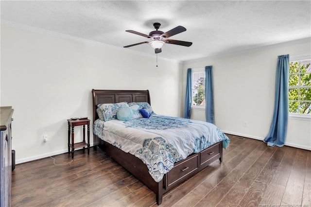 bedroom with ceiling fan, baseboards, ornamental molding, and dark wood finished floors