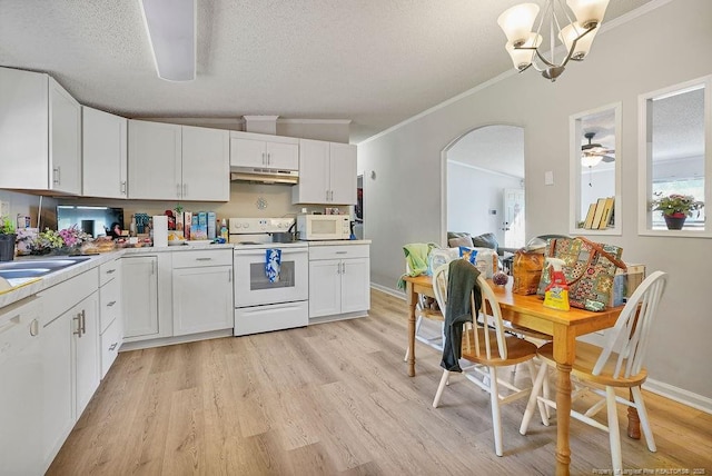 kitchen featuring white cabinets, white appliances, arched walkways, and ornamental molding