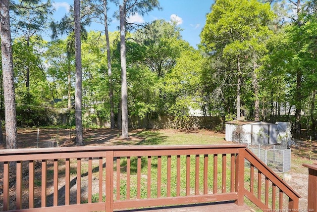 wooden deck featuring a fenced backyard and a yard