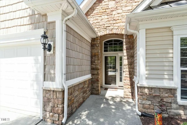 803 Footbridge Pl, Cary, NC 27519 - view of exterior entry featuring stone siding and an attached garage