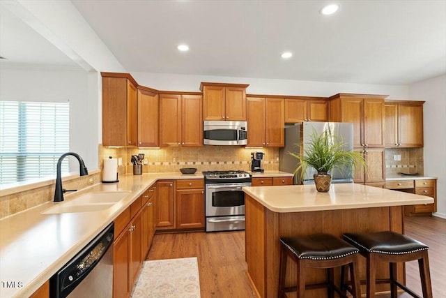 803 Footbridge Pl, Cary, NC 27519 - kitchen with a kitchen bar, light wood-type flooring, appliances with stainless steel finishes, and a sink
