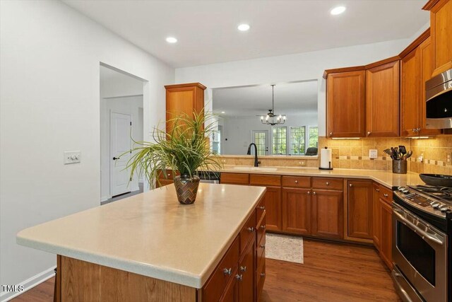 803 Footbridge Pl, Cary, NC 27519 - kitchen with stainless steel appliances, light countertops, a sink, and brown cabinetry