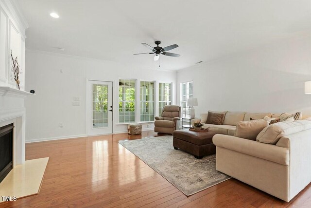 803 Footbridge Pl, Cary, NC 27519 - living room featuring a high end fireplace, light wood-style floors, ceiling fan, baseboards, and recessed lighting