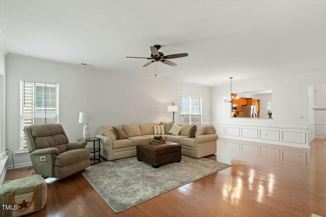 803 Footbridge Pl, Cary, NC 27519 - living area with wood finished floors, visible vents, and ceiling fan with notable chandelier