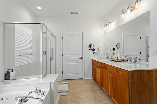 803 Footbridge Pl, Cary, NC 27519 - bathroom with double vanity, a stall shower, visible vents, tile patterned flooring, and a garden tub