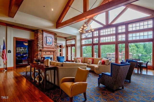 803 Footbridge Pl, Cary, NC 27519 - living area featuring beam ceiling, baseboards, high vaulted ceiling, hardwood / wood-style flooring, and a fireplace