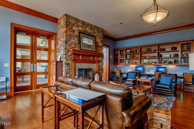 803 Footbridge Pl, Cary, NC 27519 - living room featuring wood finished floors, a fireplace, and crown molding