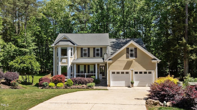 view of front of home featuring a porch, driveway, a garage, a front lawn, and a shingled roof