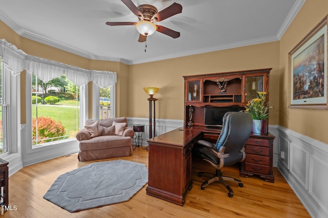 office area with crown molding, ceiling fan, and a wainscoted wall