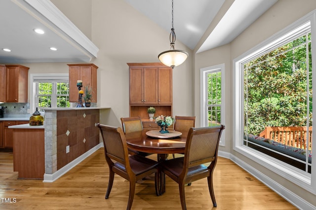 dining room with recessed lighting, baseboards, light wood finished floors, and lofted ceiling