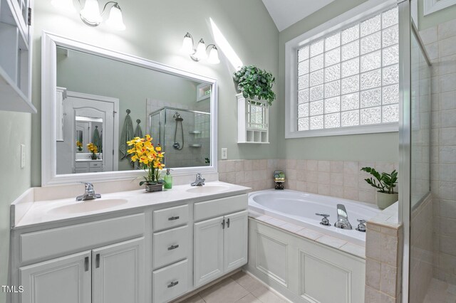 full bathroom with tile patterned flooring, a sink, a bath, and a shower stall