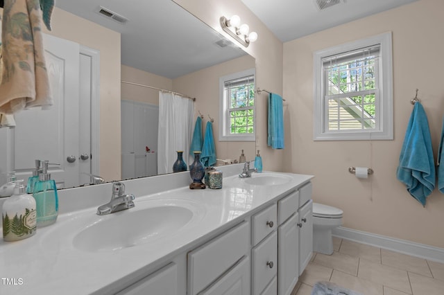 bathroom with a sink, baseboards, toilet, and visible vents