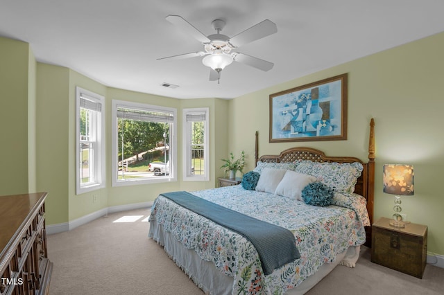 carpeted bedroom featuring baseboards, visible vents, and ceiling fan