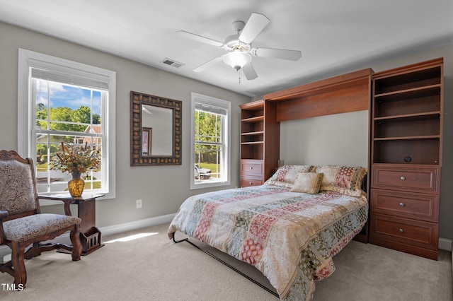 bedroom with carpet flooring, a ceiling fan, baseboards, and visible vents