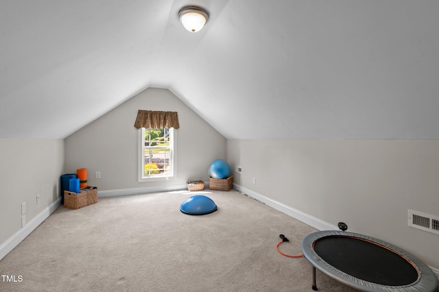 exercise room with baseboards, visible vents, carpet, and lofted ceiling