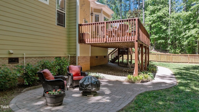 view of patio / terrace with fence, a wooden deck, stairs, and an outdoor fire pit