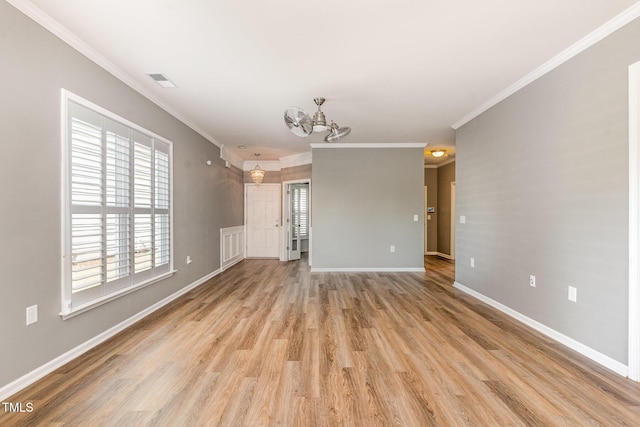 unfurnished living room featuring a notable chandelier, crown molding, visible vents, and light wood-type flooring