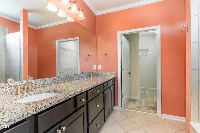 bathroom featuring double vanity, crown molding, and a sink