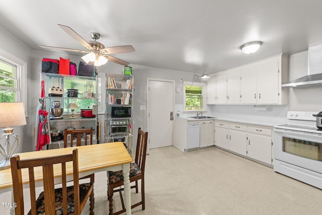 kitchen featuring white appliances, a sink, white cabinets, light countertops, and a ceiling fan