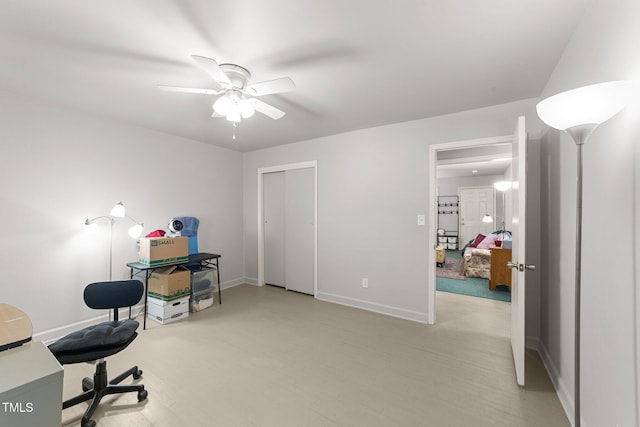 office with a ceiling fan and baseboards