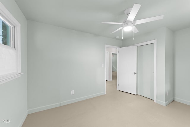 unfurnished bedroom featuring a closet, baseboards, and a ceiling fan