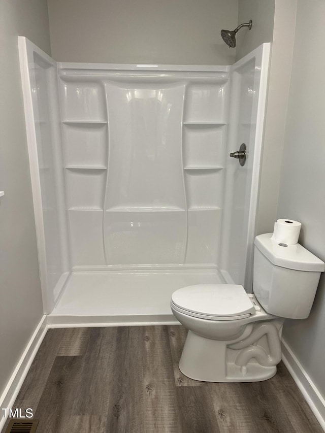 1165 John Mitchell Rd, Youngsville, NC 27596 - full bathroom featuring a shower, baseboards, wood finished floors, and toilet