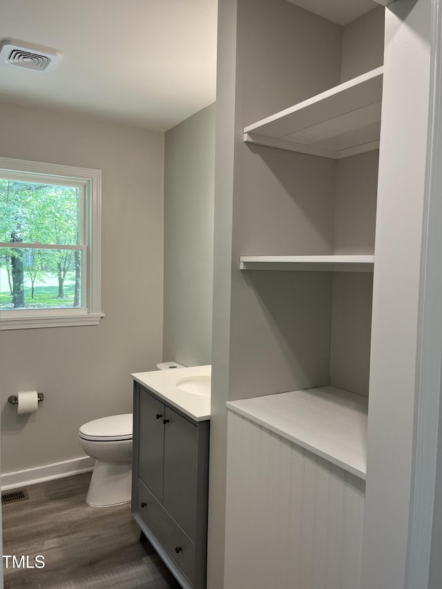 1165 John Mitchell Rd, Youngsville, NC 27596 - bathroom featuring vanity, toilet, wood finished floors, and visible vents
