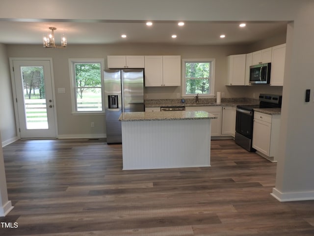 1165 John Mitchell Rd, Youngsville, NC 27596 - kitchen with a center island, baseboards, white cabinets, stainless steel appliances, and recessed lighting