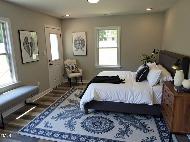 1165 John Mitchell Rd, Youngsville, NC 27596 - bedroom with baseboards, visible vents, multiple windows, and wood finished floors