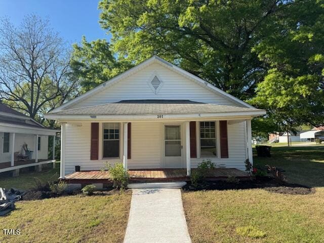 207 Harris St, Norlina, NC 27563 - bungalow-style house featuring a front lawn, roof with shingles, and covered porch