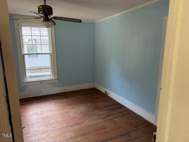 207 Harris St, Norlina, NC 27563 - empty room with crown molding, a ceiling fan, baseboards, and dark wood-style flooring