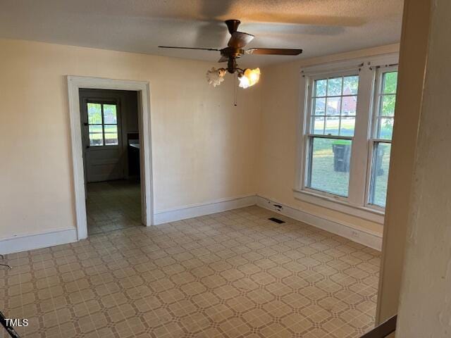 207 Harris St, Norlina, NC 27563 - unfurnished room featuring a wealth of natural light, a ceiling fan, baseboards, and visible vents