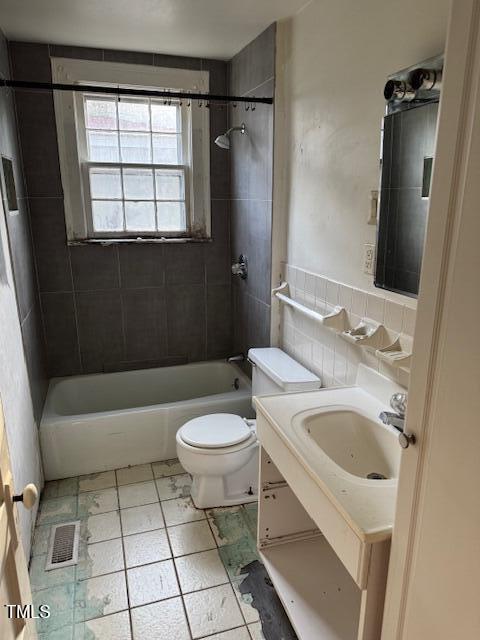 207 Harris St, Norlina, NC 27563 - full bathroom featuring vanity, toilet, shower / bathtub combination, tile patterned flooring, and visible vents