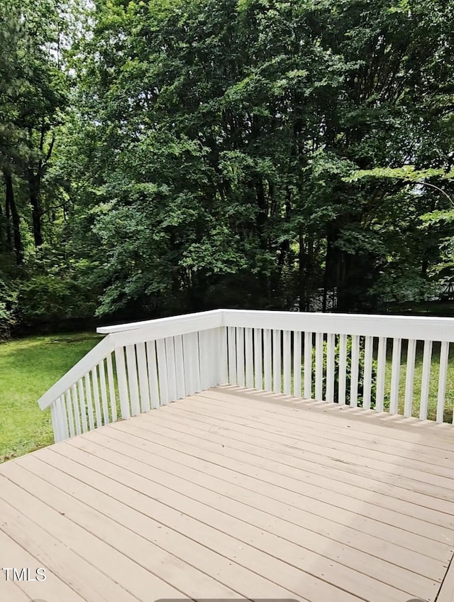 wooden deck with a lawn