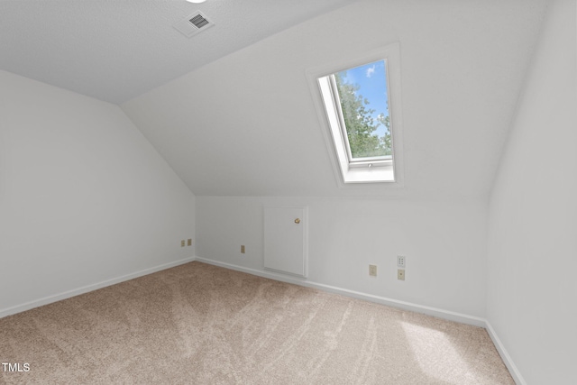 additional living space with carpet floors, baseboards, and lofted ceiling