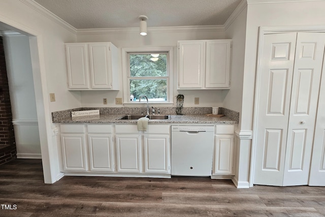 kitchen featuring white dishwasher, a sink, white cabinets, dark wood-style flooring, and crown molding