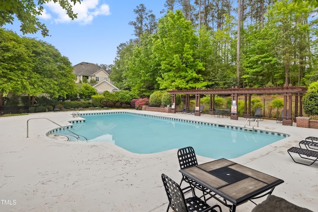 community pool with a patio, fence, and a pergola
