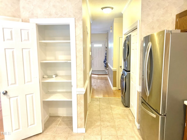 5500 Fortunes Ridge Dr Unit 82B, Durham, NC 27713 - washroom with stacked washer / dryer, light tile patterned floors, and built in shelves