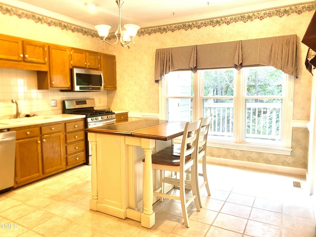 5500 Fortunes Ridge Dr Unit 82B, Durham, NC 27713 - kitchen with stainless steel appliances, brown cabinetry, plenty of natural light, and ornamental molding